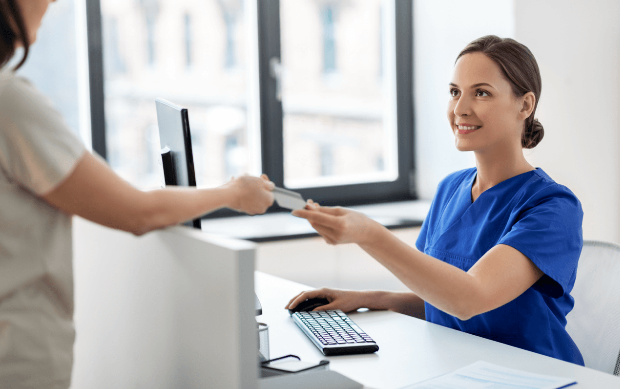 Patient Passing Documents to Receptionist Patient Passing Documents to Receptionist