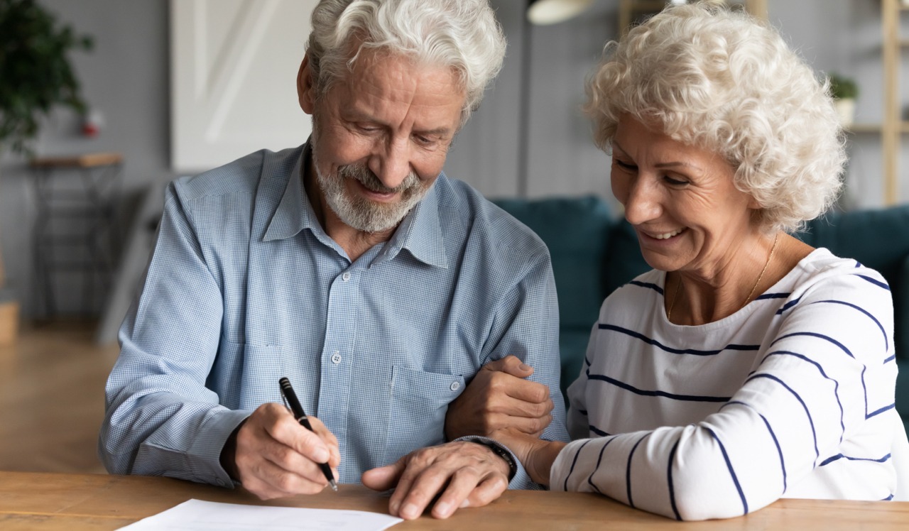 Couple Signing Documents